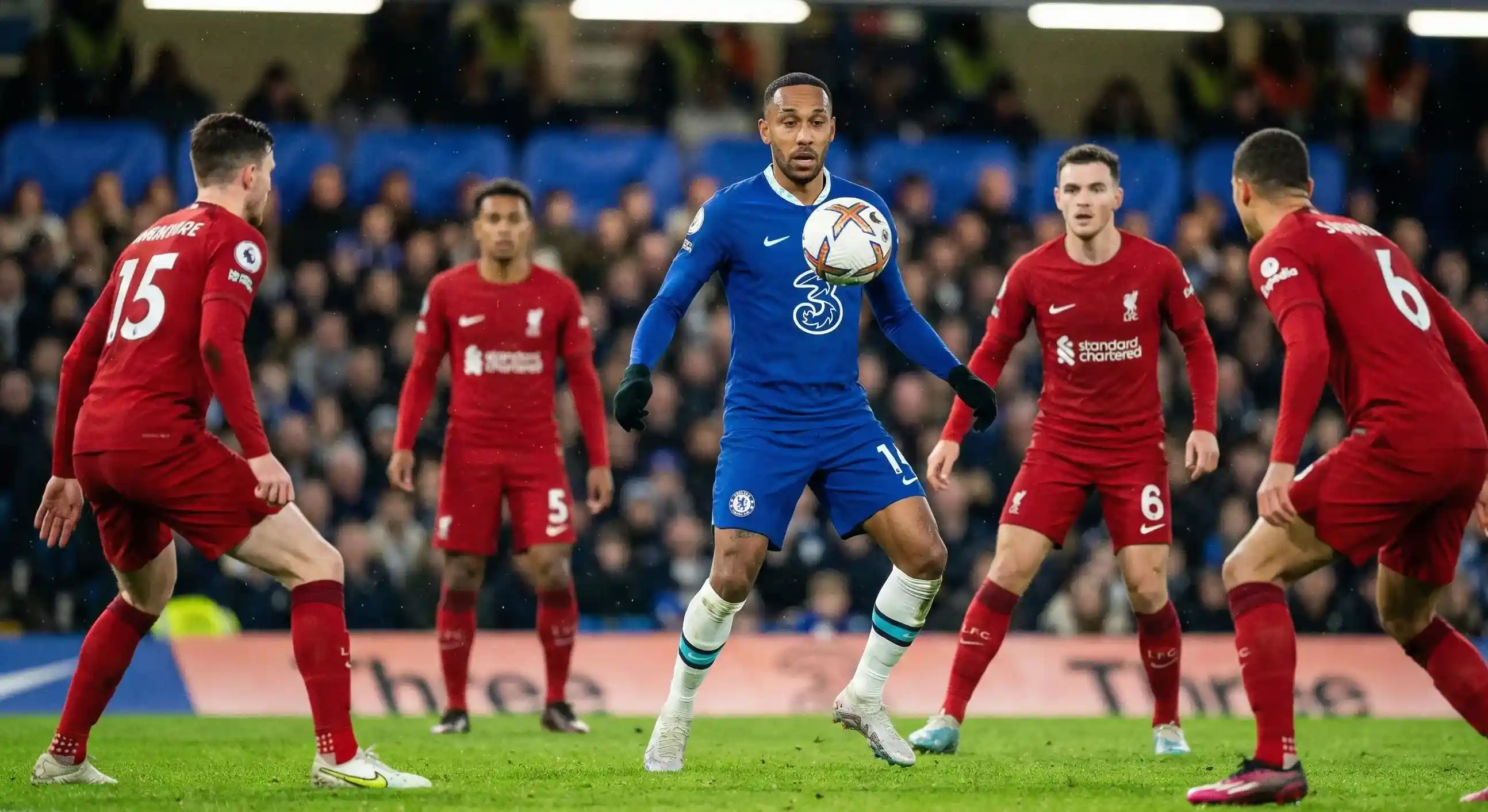 Football attacker in focus receiving the ball with defenders nearby