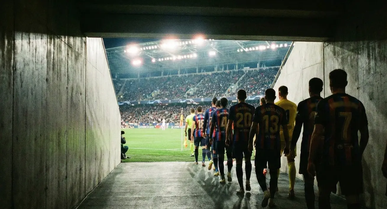 Football team walking onto a stadium pitch before a match