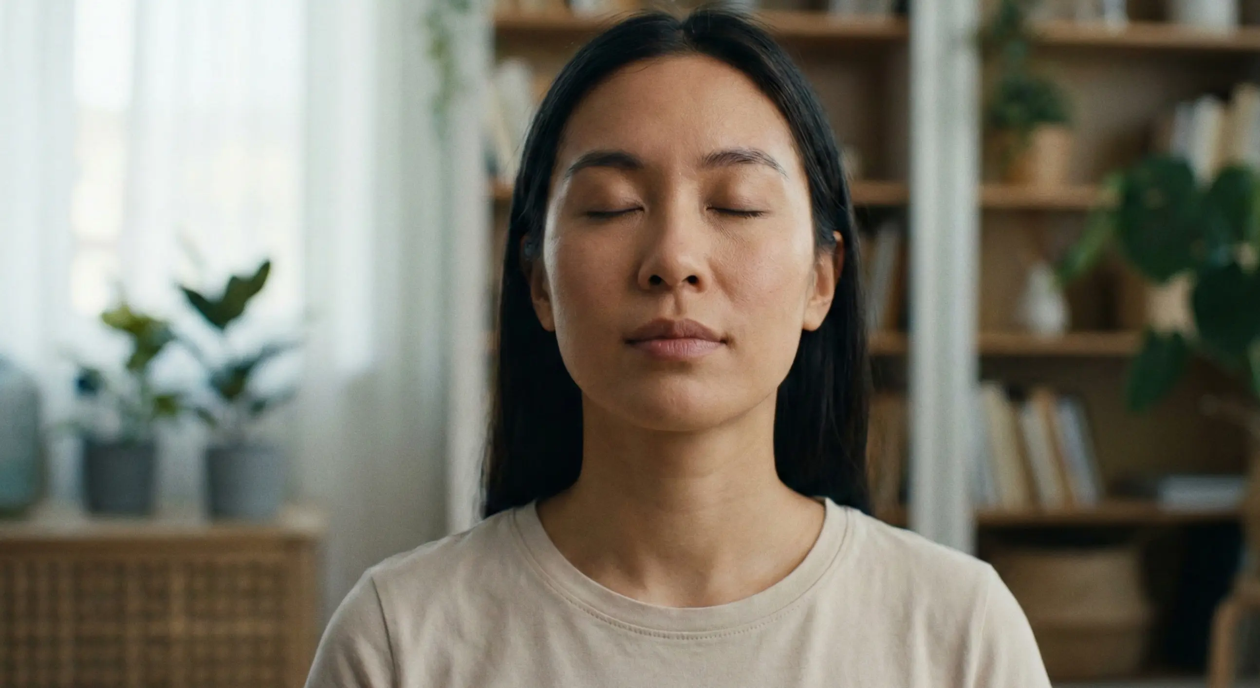 Person taking a deep breath with eyes closed showing self-control