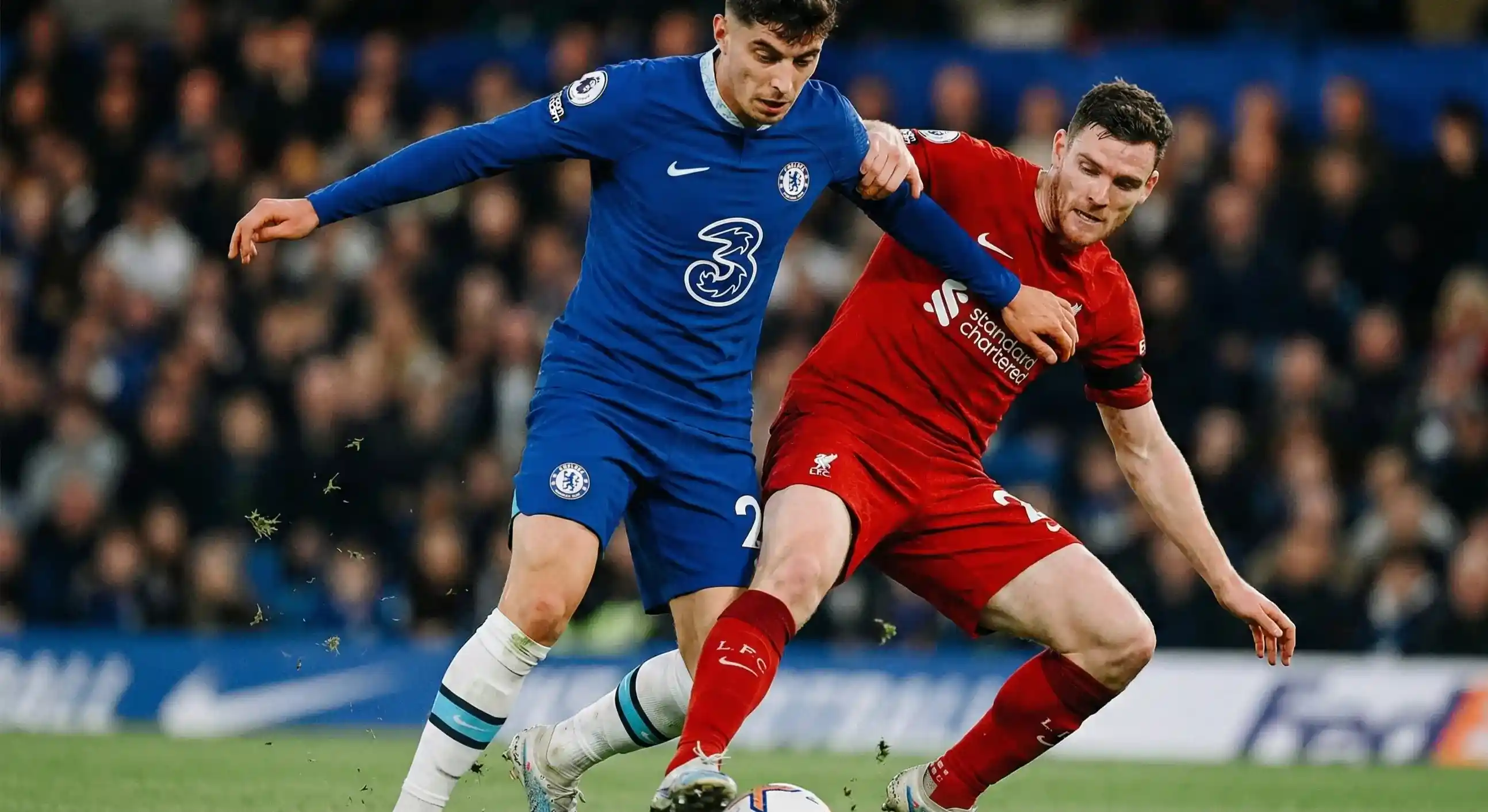Football players competing intensely for the ball in midfield during a match
