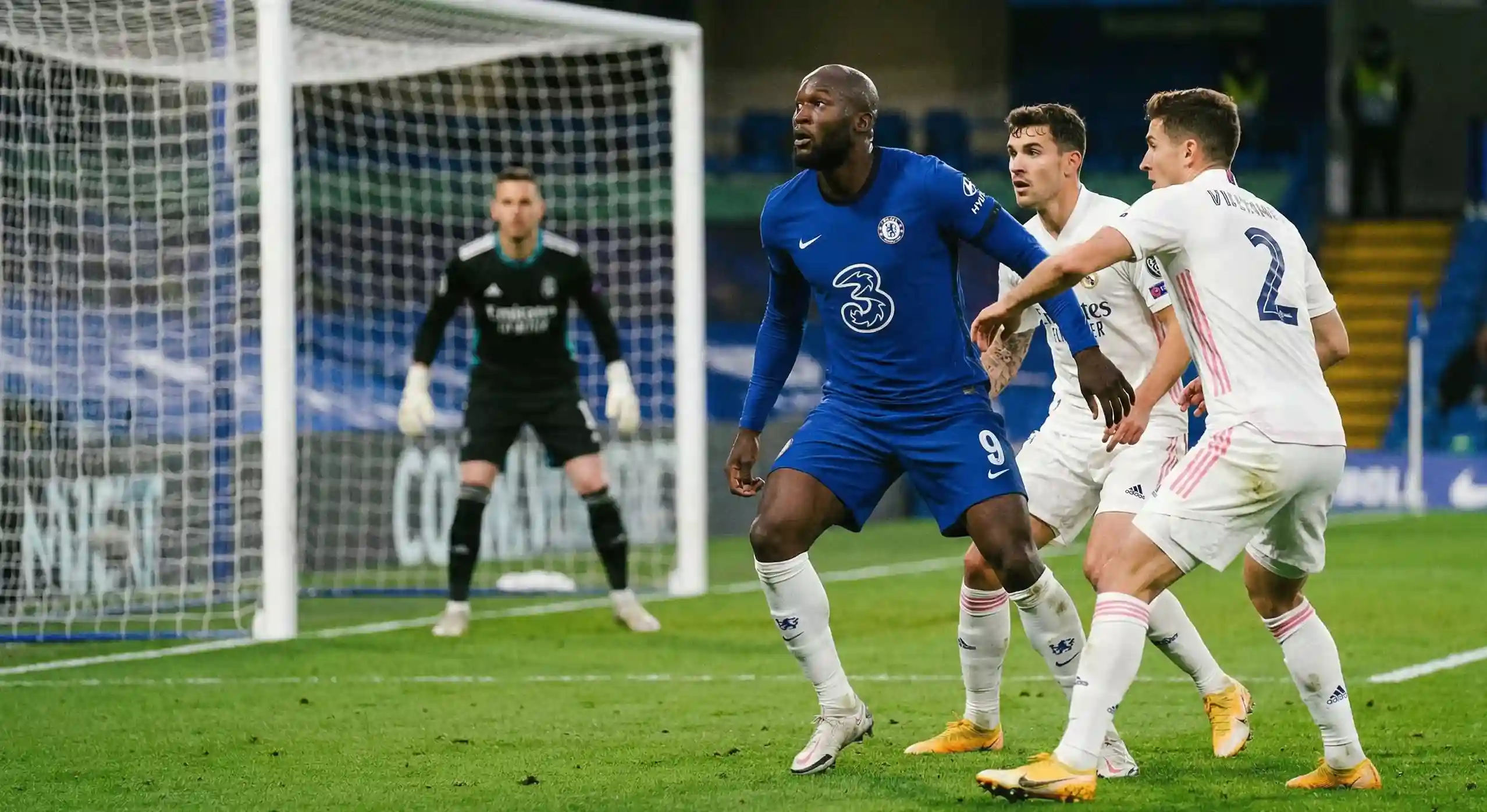 Football forward positioning himself in the penalty area awaiting a cross