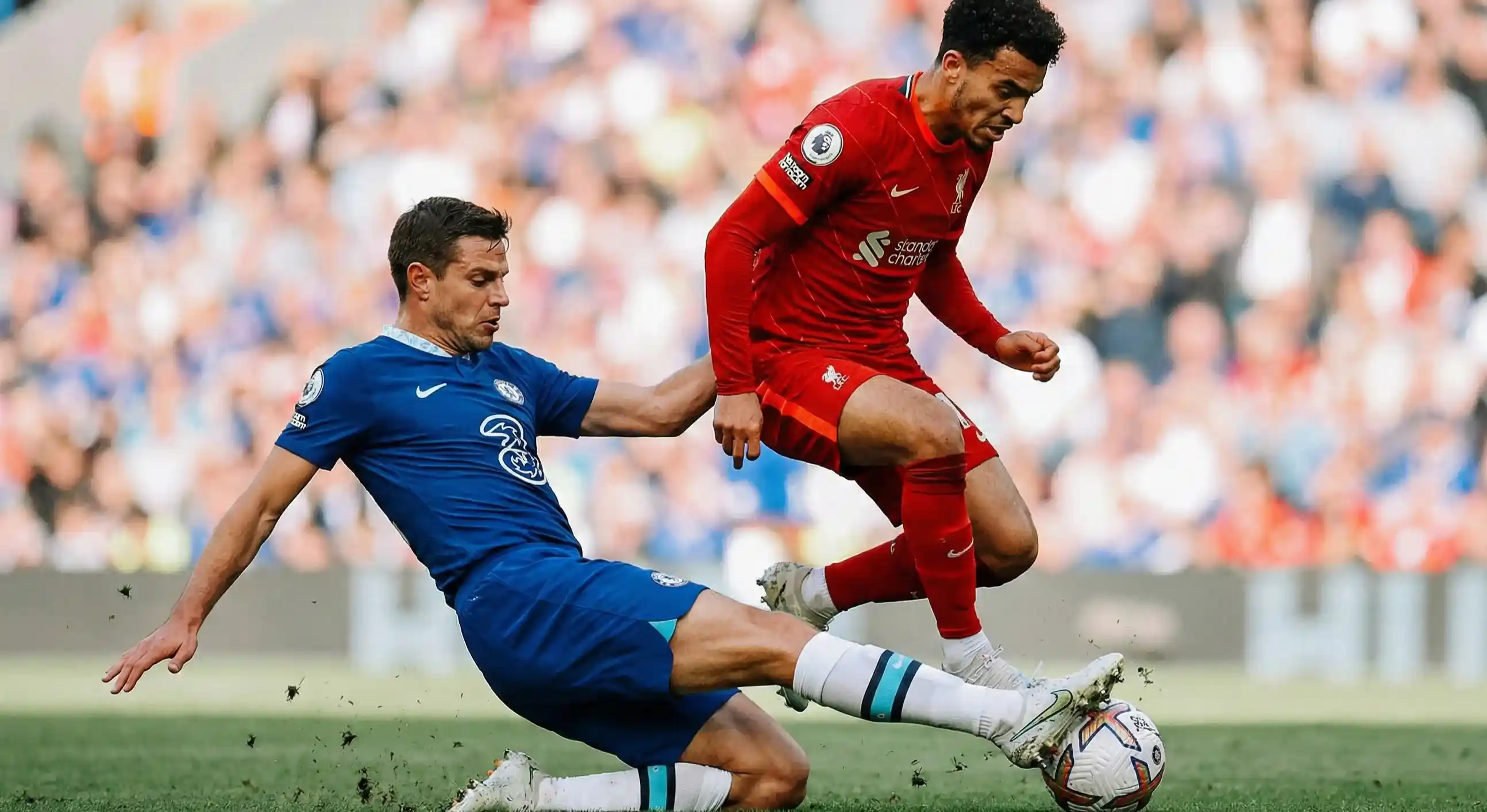 Football midfielder making a sliding tackle challenge during a match